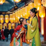 24241493-923470624-A-captivating-photograph-capturing-the-essence-of-the-Lantern-Festival-where-two-young-girls-don-traditional-Song-clothes-in-l